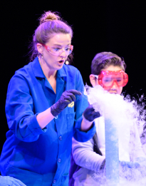 Scientist and child performing an experiment from Arts Access education program